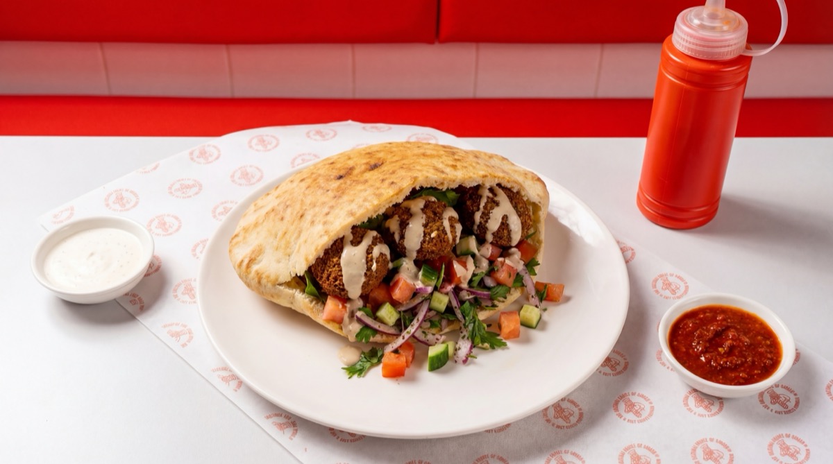 Homemade falafel in pita with vegetables and sauces